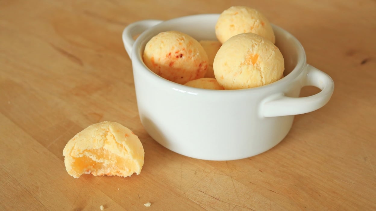 Cheese bread pão de queijo in a small white crock. 