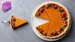 Pumpkin pie with a slice removed and on a spatula.