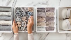 Hands sorting clothing into individual trays with like items together