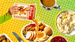 A hand pouring gravy out of a box and straight onto a plate of Thanksgiving food.