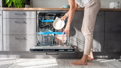 Woman loading dishwasher