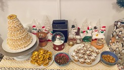 A christmas snack table with a kransekake, almonds, and mince pies.