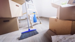 boxes and broom in empty room