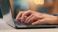 hands on laptop keyboard 