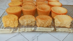 Four different types of cupcakes on a wire rack.