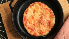 Pizza in a cast iron skillet.