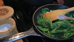 A skillet of spinach with a sprinkle of MSG.