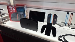switch 2 and accessories in a display case