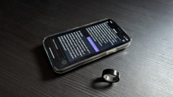 Oura Advisor on phone next to Oura ring