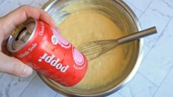A can of cola held over a bowl of cake batter.