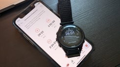 Phone showing Strava race predictions, and a Garmin watch showing a different number