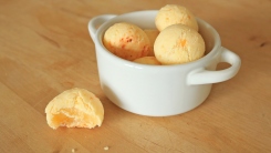 Cheese bread pão de queijo in a small white crock.