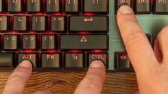 Hand pressing "ctrl/alt/delete" on keyboard