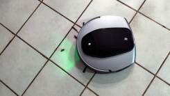 robovac about to vacuum debris