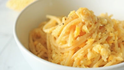 A bowl of corn alfredo spaghetti.
