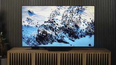 screenshot of a smart TV on a TV stand with snowy scene on picture