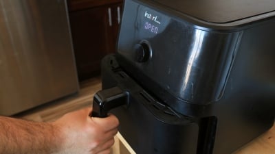 A person pulling open an instant vortex air fryer.