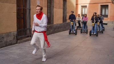 A still from Conan O'Brien Must Go in which he runs from a crowd chasing him