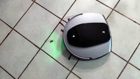 robovac about to vacuum debris