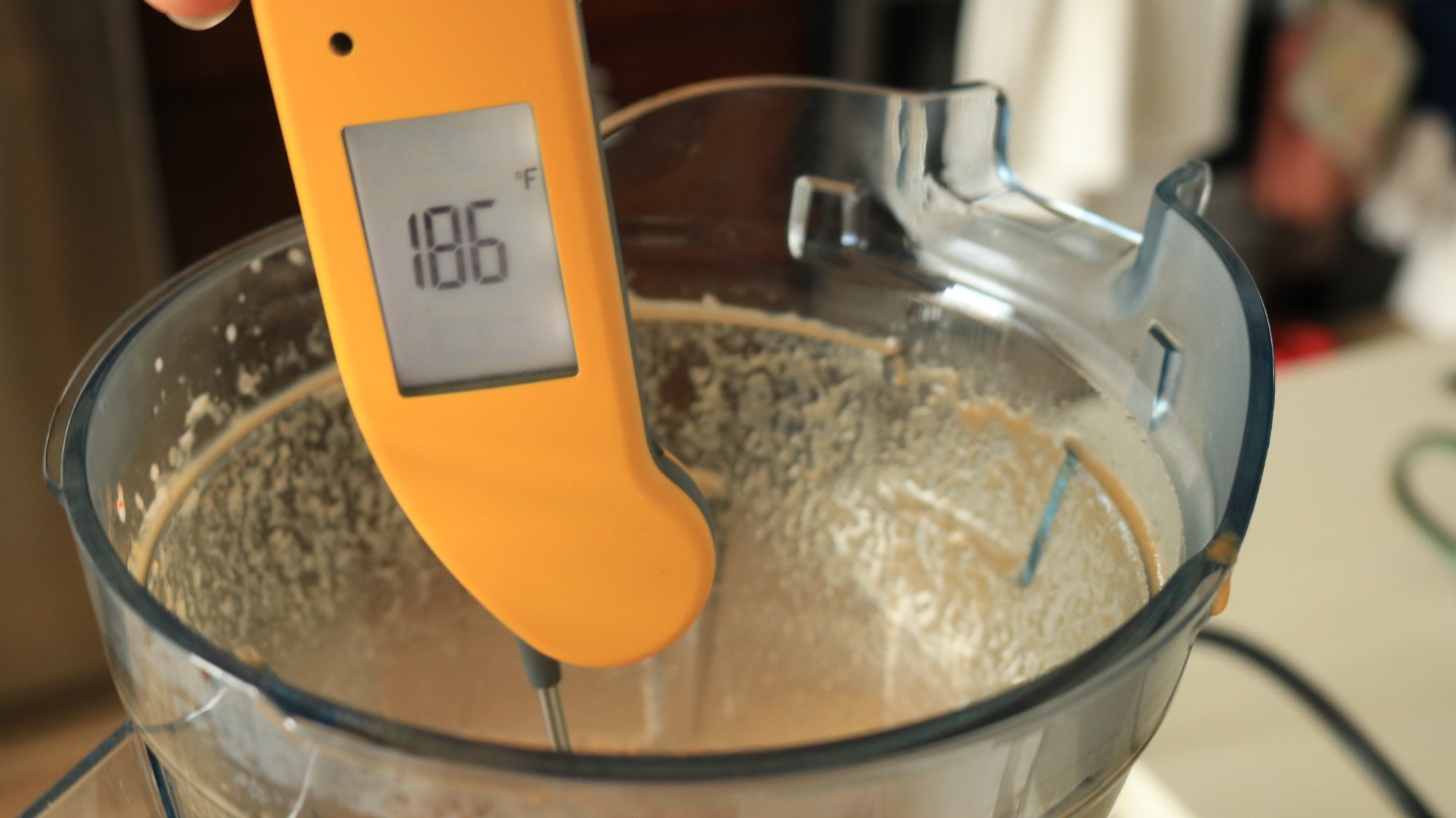 A thermometer inserted in a blender container reads 186 degrees Fahrenheit.