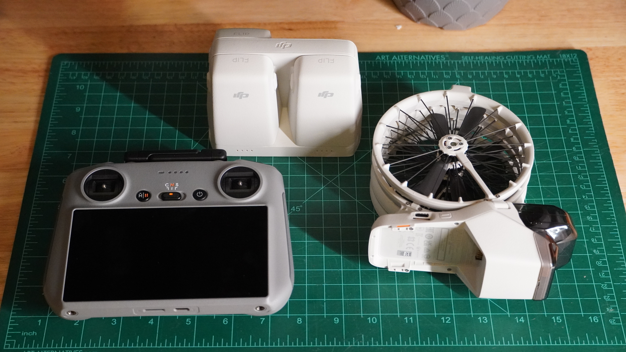 DJI Flip folded on a desk with accessories