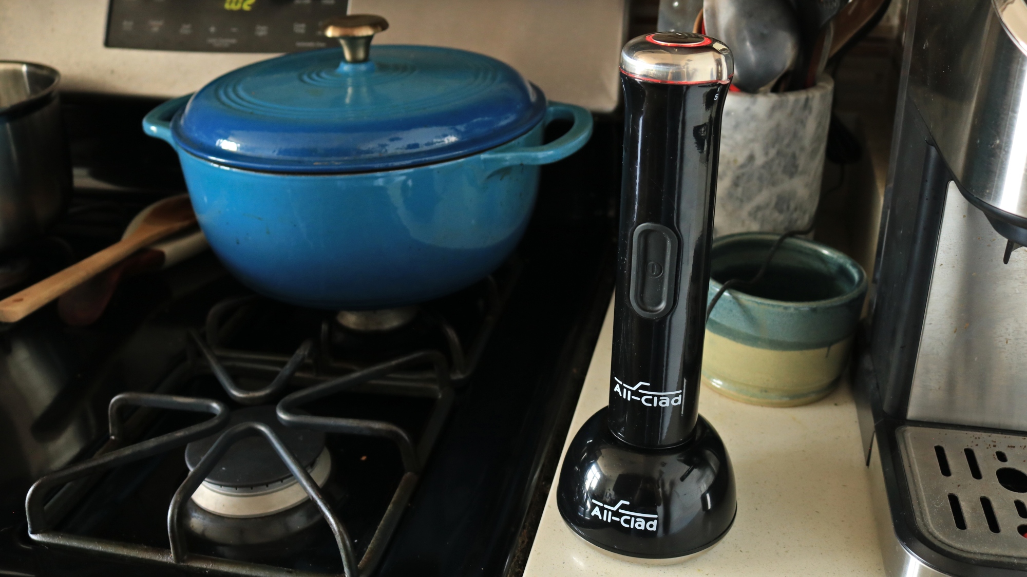 An All-Clad blender on a charger station.