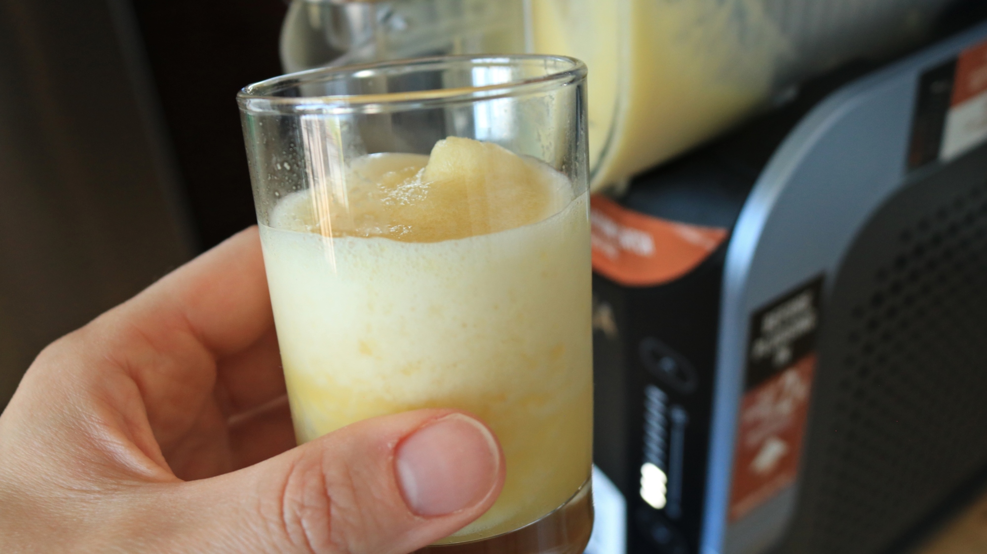 A small cup of pineapple slushie.