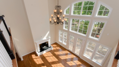 inside of a home with high ceilings and custom-sized windows