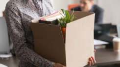 Close up of employee leaving work with all belongings in box
