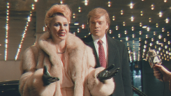 Ivana Trump (Maria Bakalova) and Donald Trump (Sebastian Stan) pose for photographers in a scene from The Apprentice