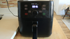 A black Instant Vortex air fryer on a counter top.