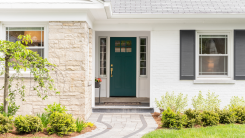 A home's entryway with clean landscaping in the front yard