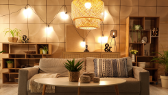 Interior of living room with sofa, table and glowing lamps in evening
