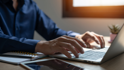 person typing on a laptop