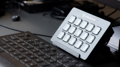 Elgato Stream Deck on a black desk near a keyboard