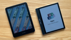 Kindle Colorsoft sitting next to Bigme B751C on a table, both showing their respective screensaver images
