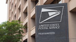 A USPS sign outside a government building
